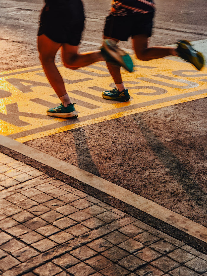 Runner on a city road at sunrise